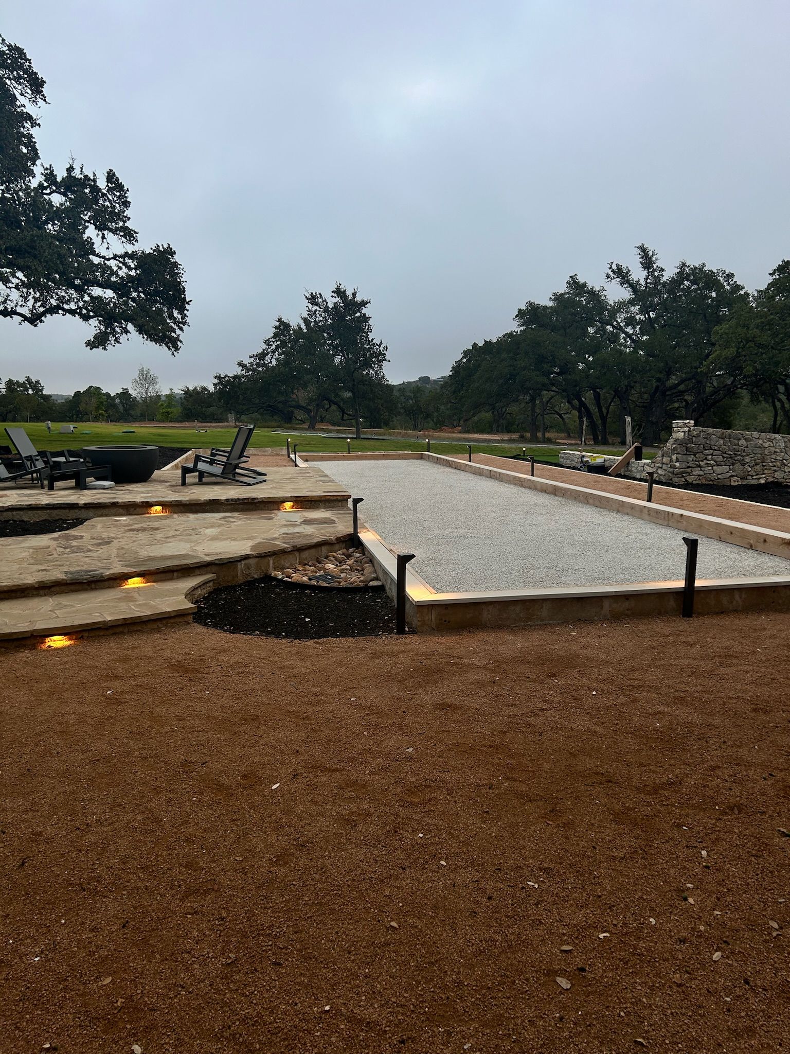 There is a fire pit in the middle of the yard.