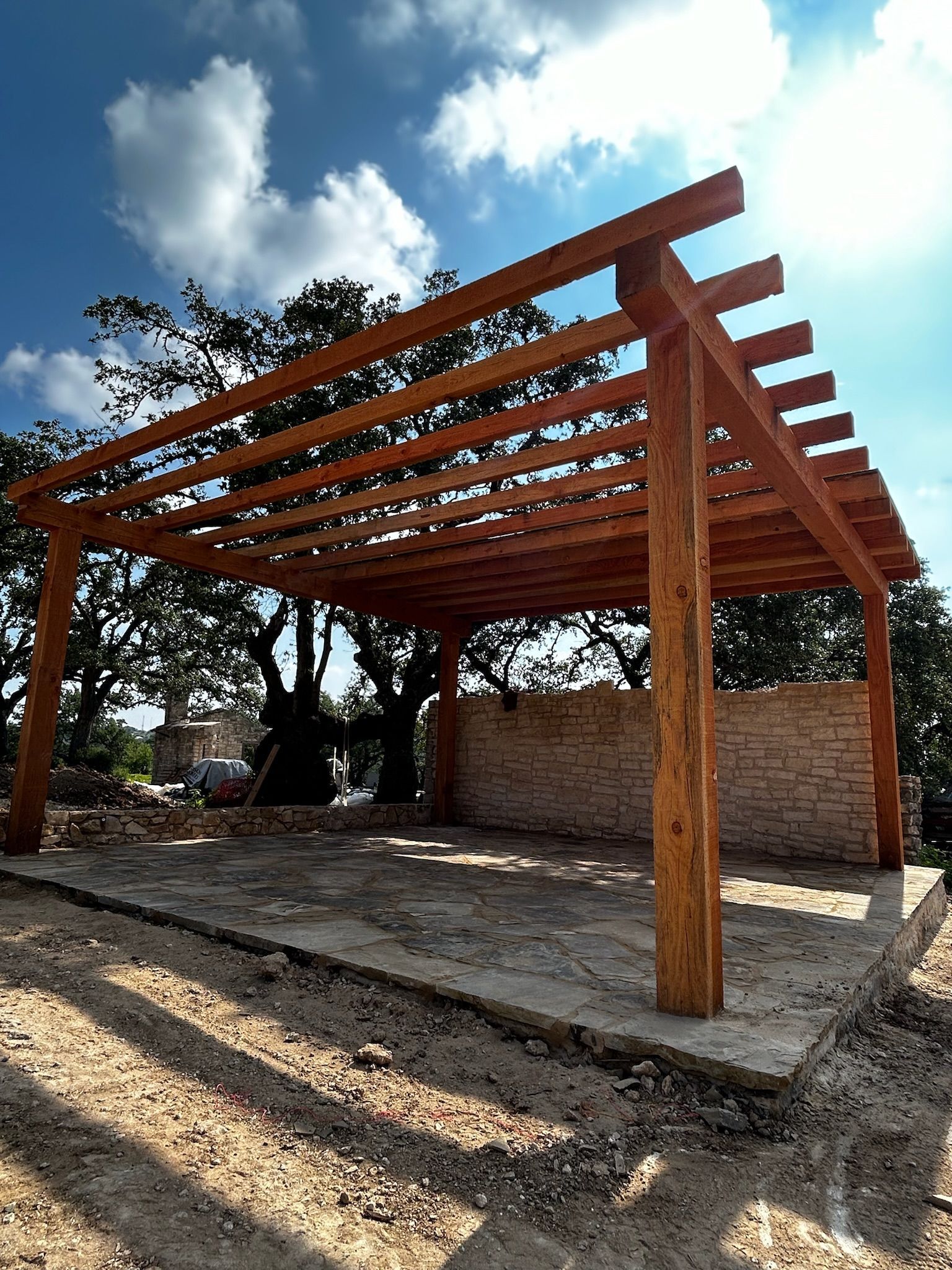 A wooden pergola with a blue sky in the background