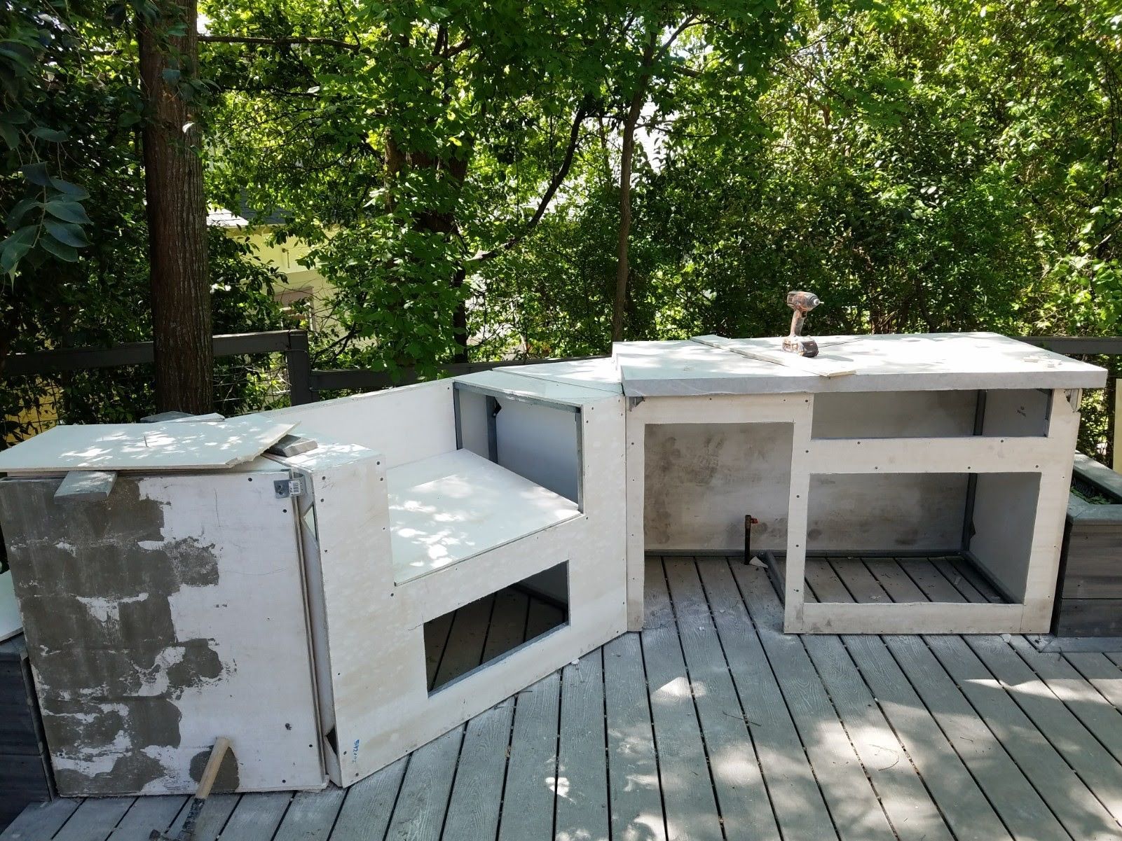 A wooden deck with a few pieces of furniture on it