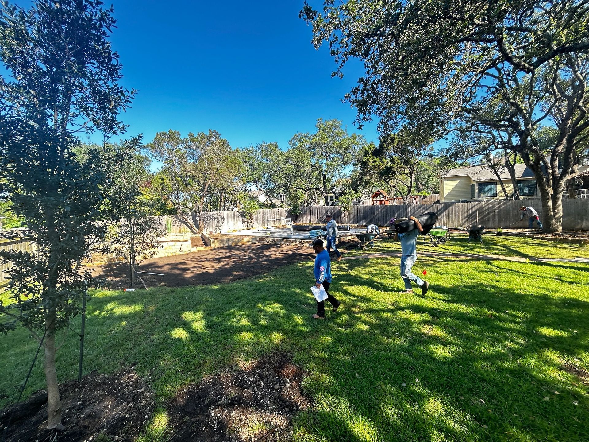 A group of children are playing in a park on a sunny day.