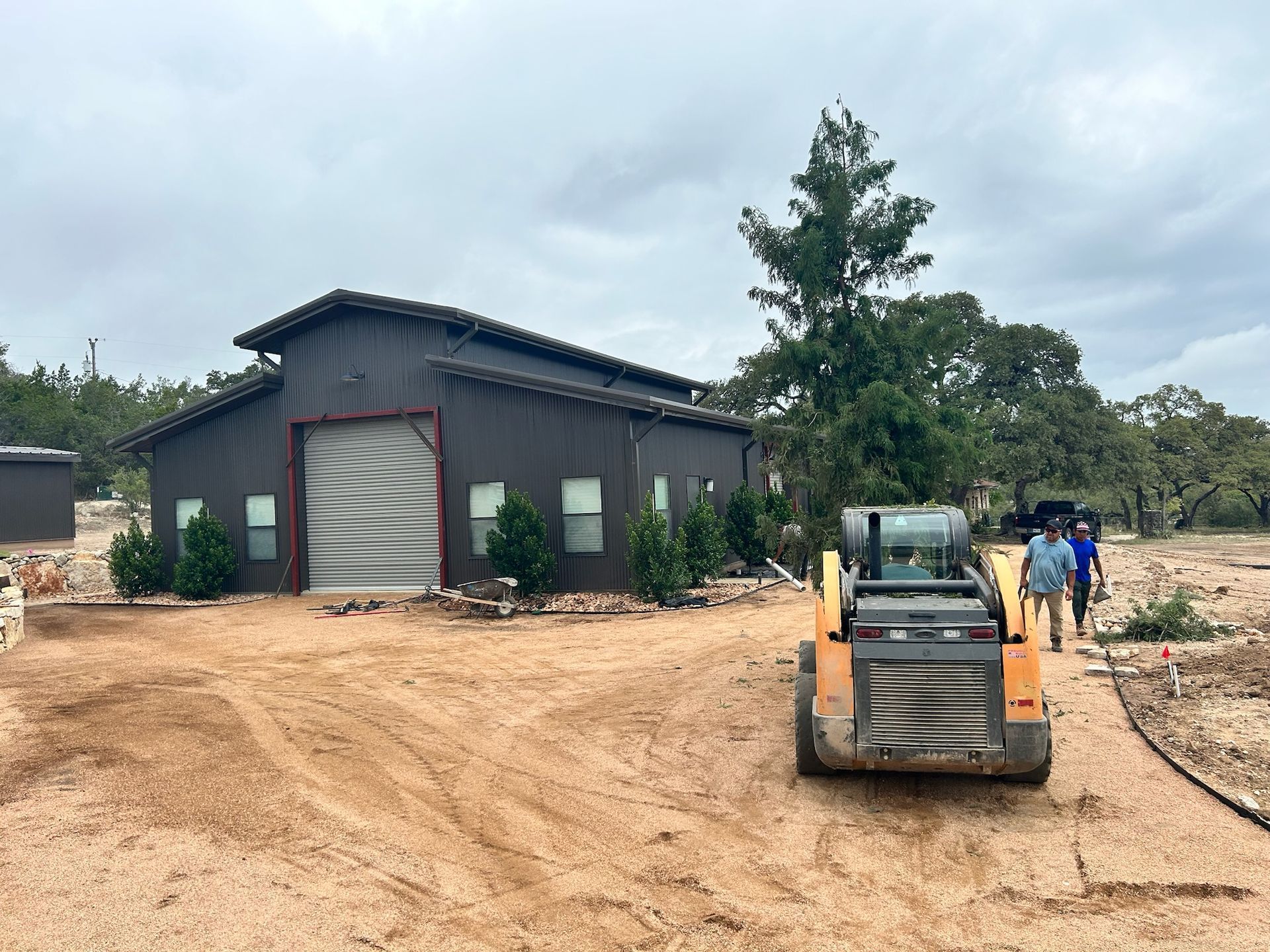 A small bulldozer is parked in front of a large building.