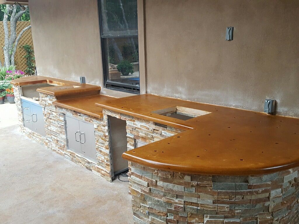 A kitchen with a wooden counter top and a sink.