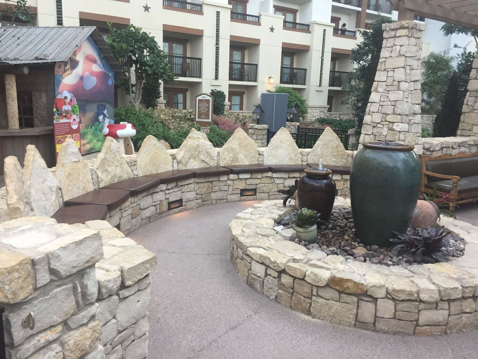 A stone wall with a large pot in the middle of it