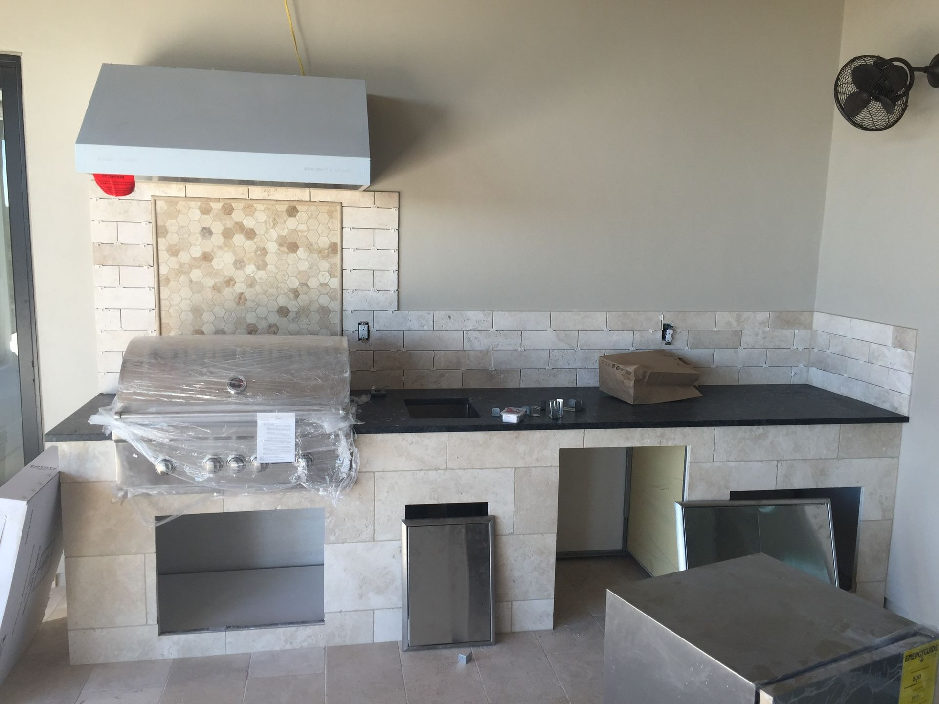 A kitchen with a grill and a sink in it