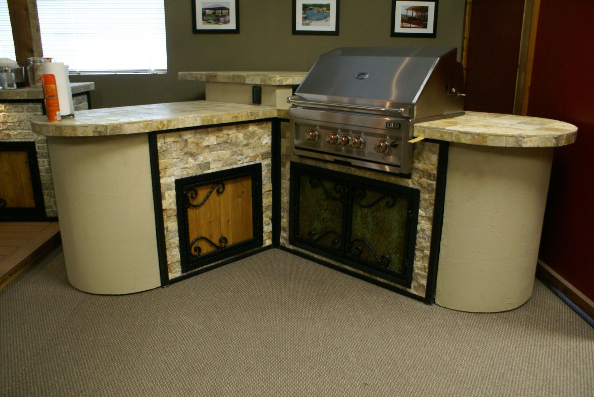 A kitchen with a stainless steel grill and a fireplace