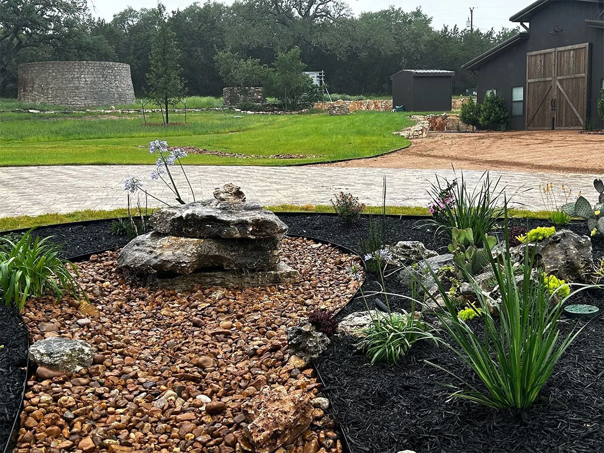 There is a fountain in the middle of the garden.