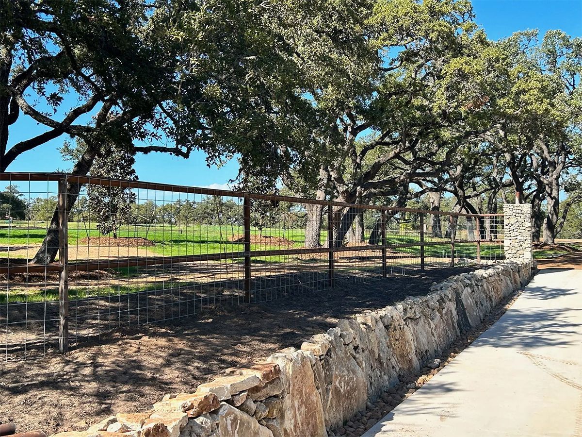 There is a stone wall along the side of the road.