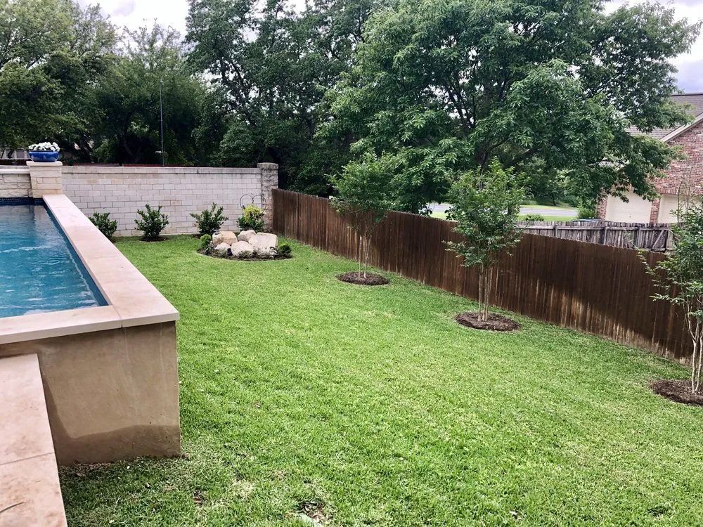 There is a swimming pool in the backyard of a house.