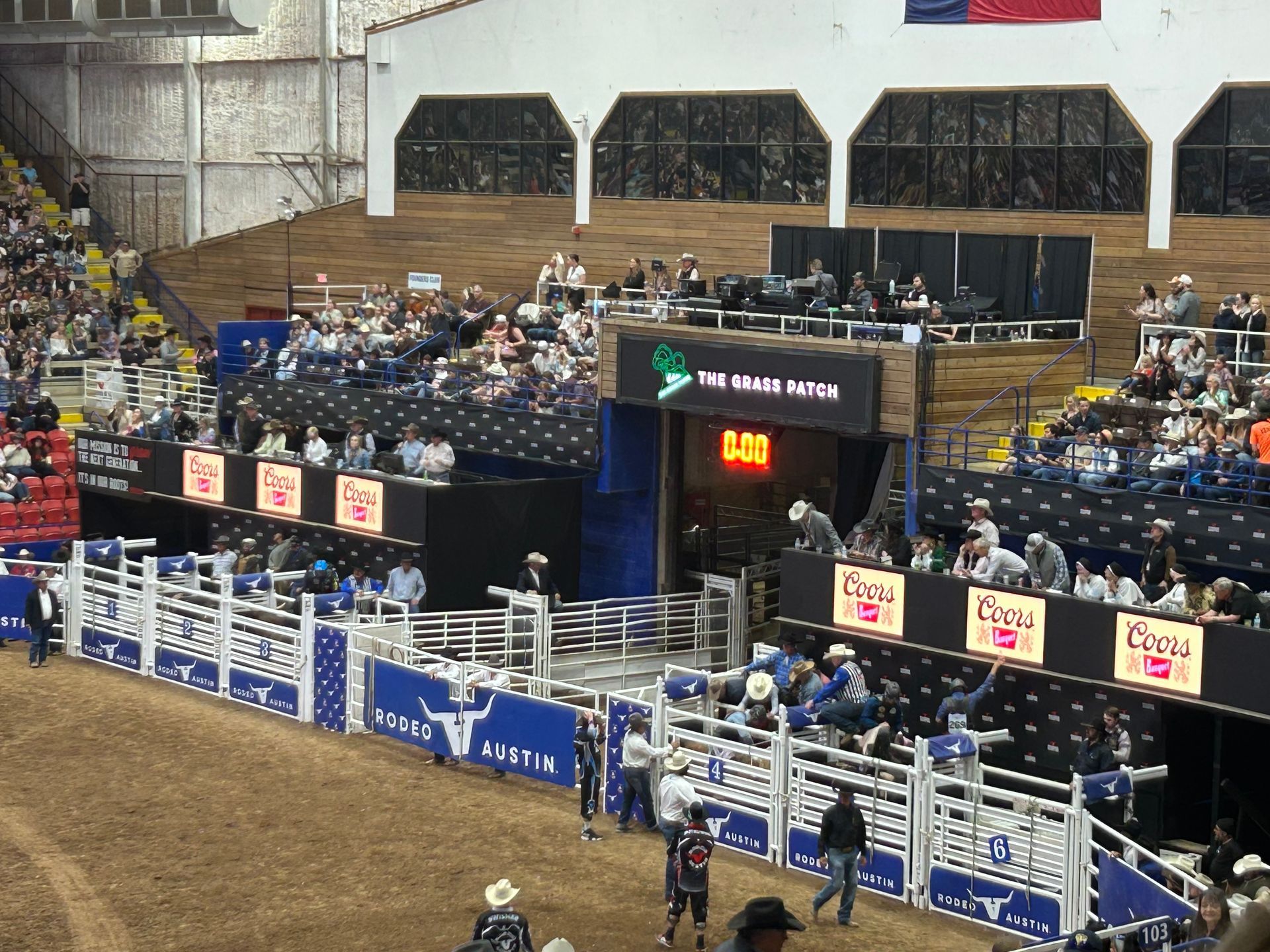 A rodeo arena filled with people and a sign that says ' the lone wolf ' on it
