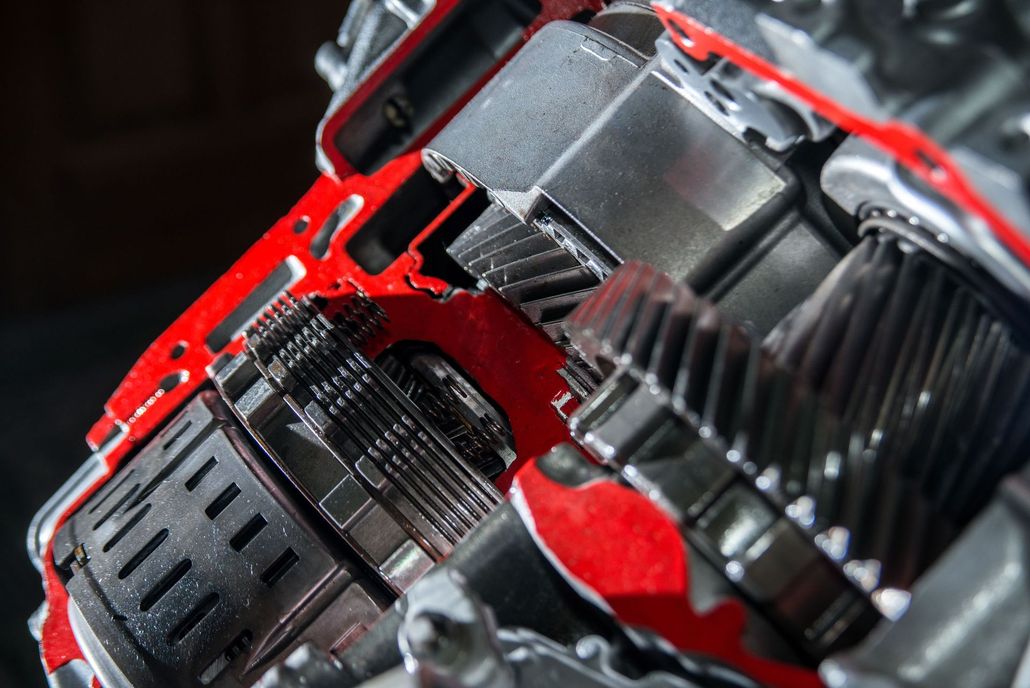 Close-up of a red and black mechanical engine or machine interior with metal components