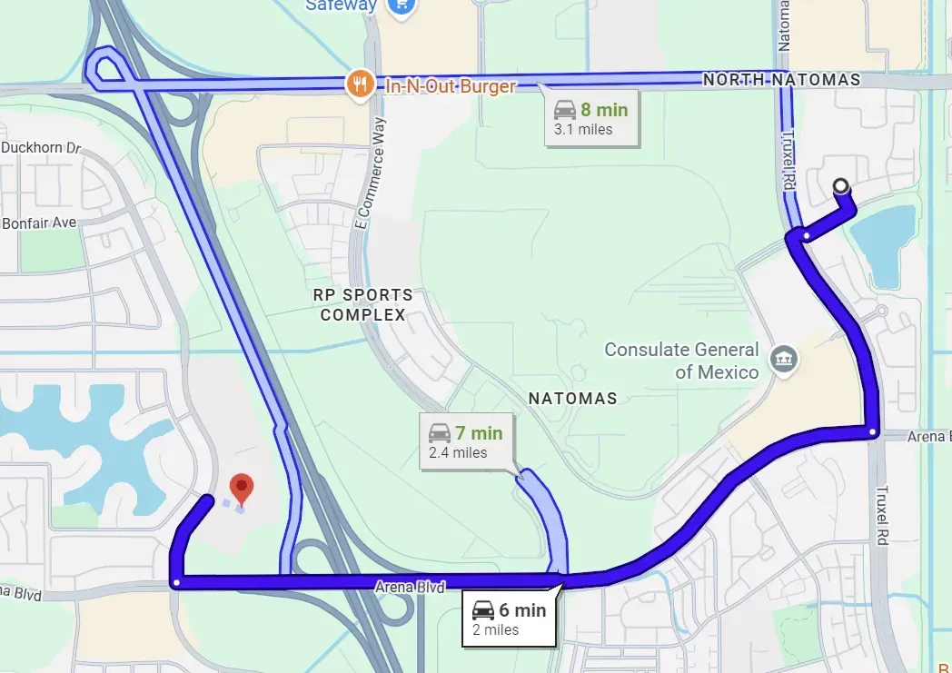 Map showing a blue route across a campus with a red location pin near the lower left.