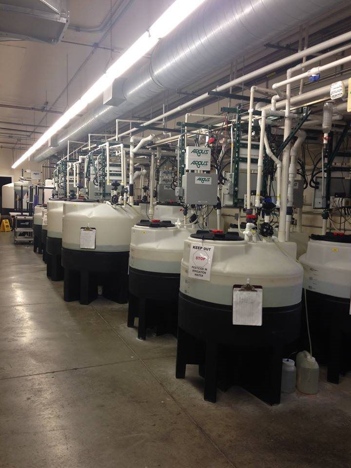 A warehouse filled with lots of tanks and pipes.