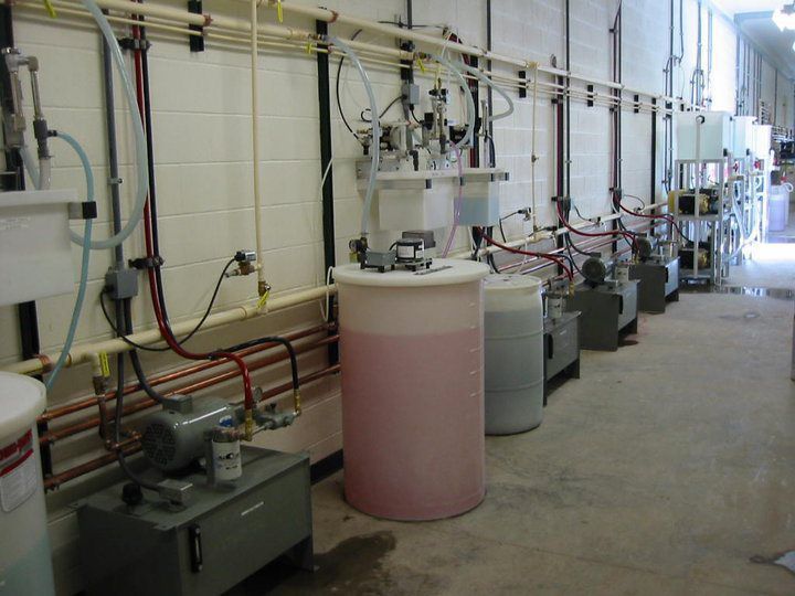 A row of tanks filled with red liquid in a room