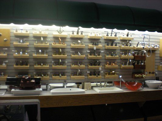 A display of sinks and faucets in a store