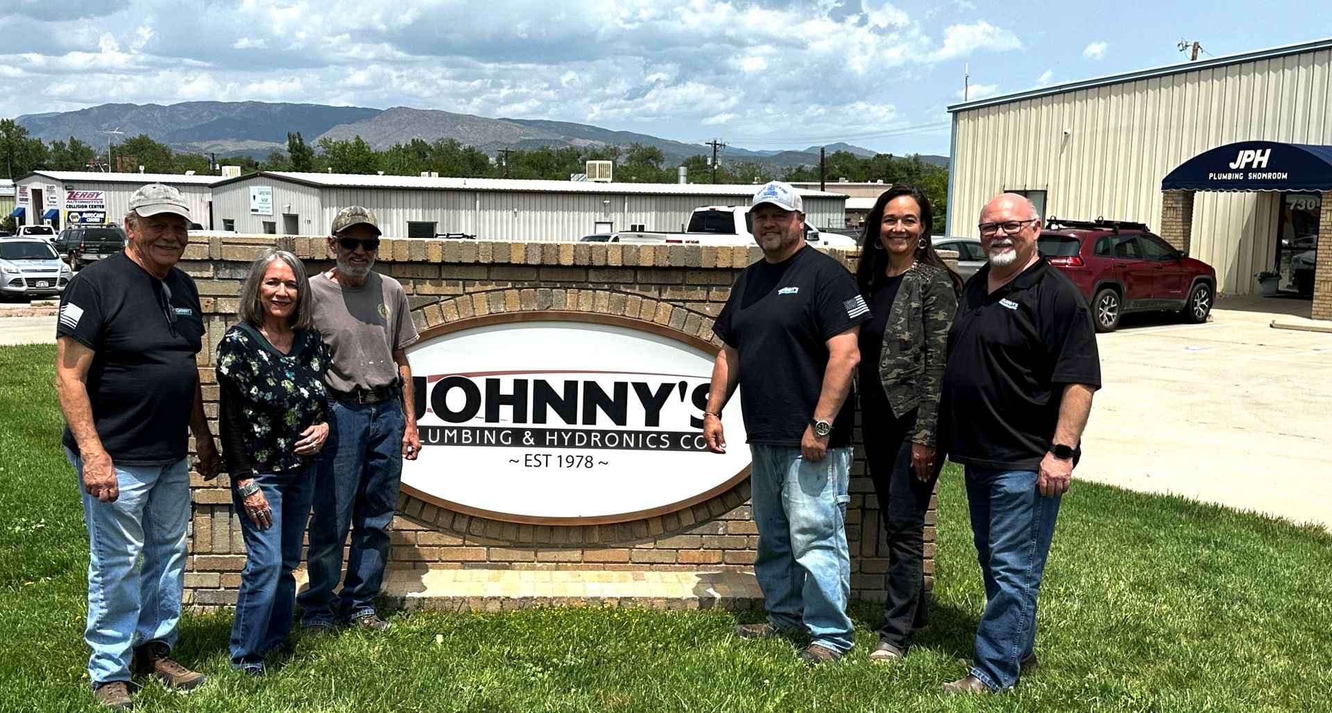 Group of people standing in front of a 