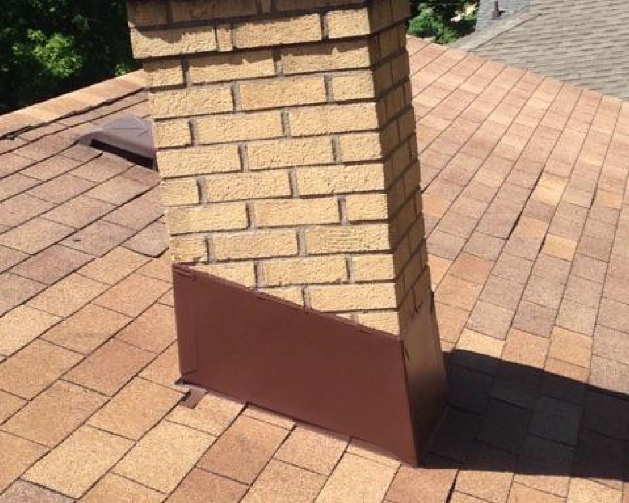 A brick chimney on top of a brick roof