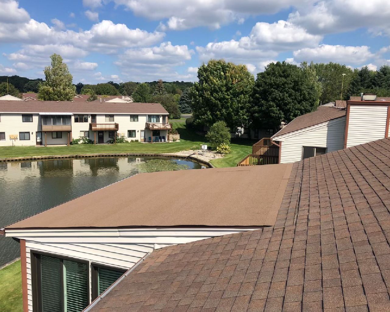 A view of a lake from the roof of a house