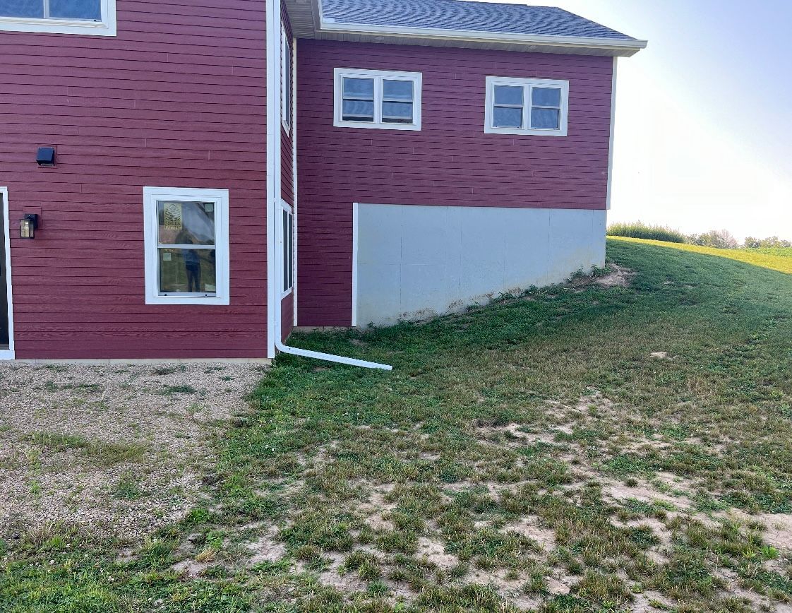 A red brick house with a brick wall in front of it