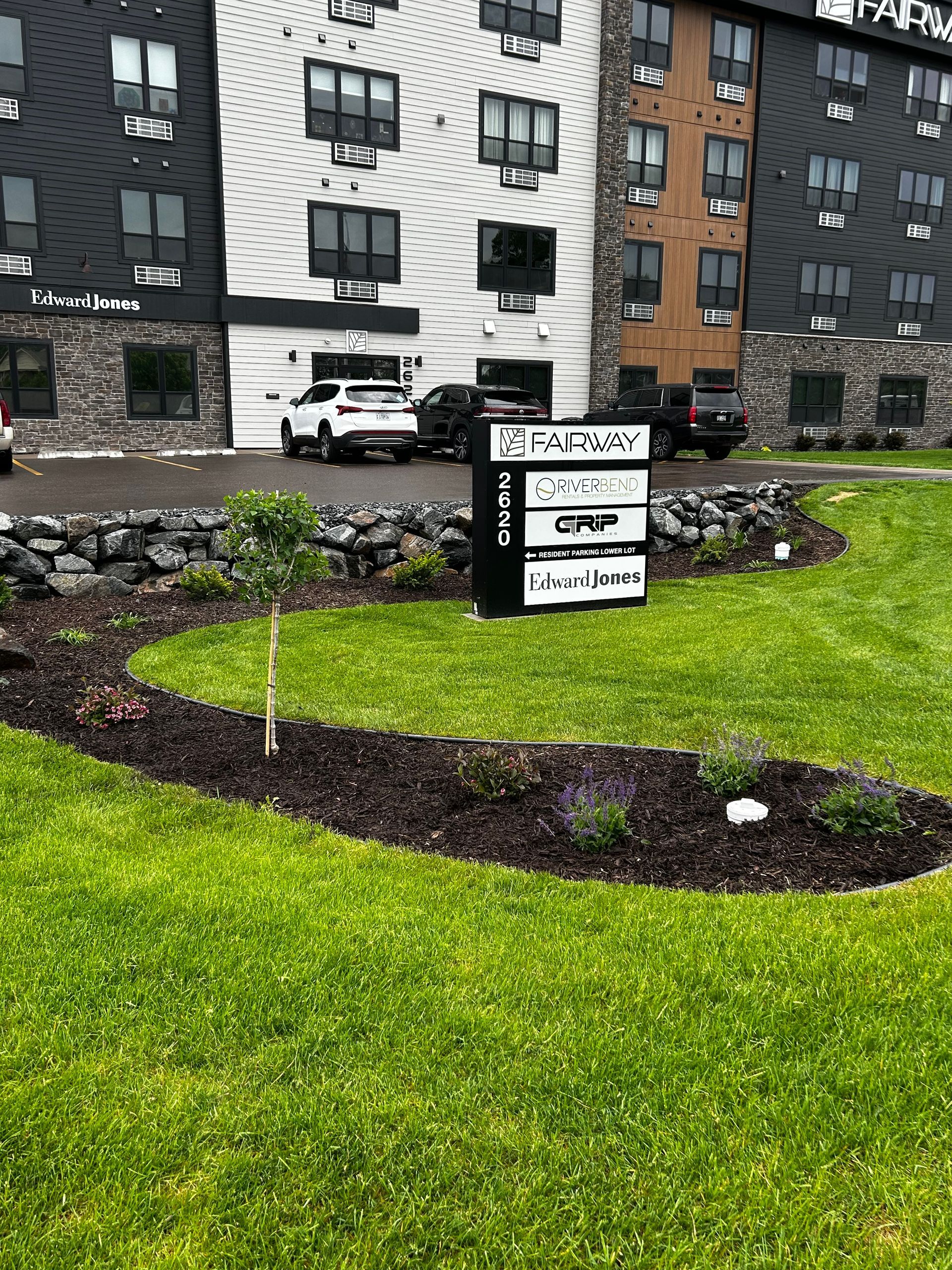 A large building with a sign in front of it.