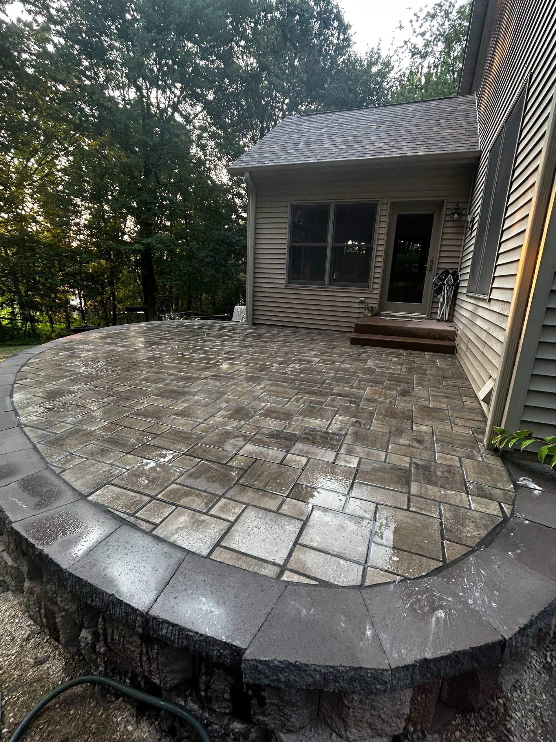 A patio is being built in front of a house.