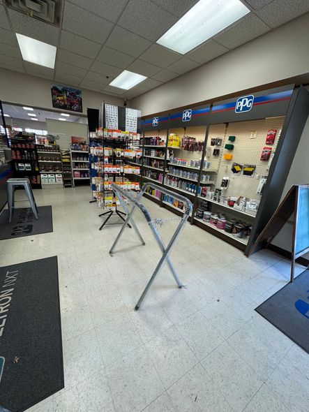 A store with a lot of shelves and a table in the middle of the room.