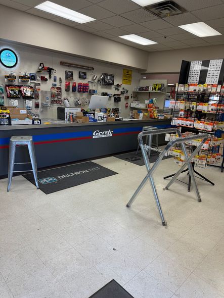 The inside of a store with a counter and stools