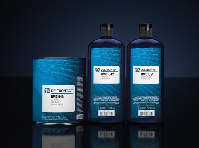 Three bottles of deltron paint are sitting on a table