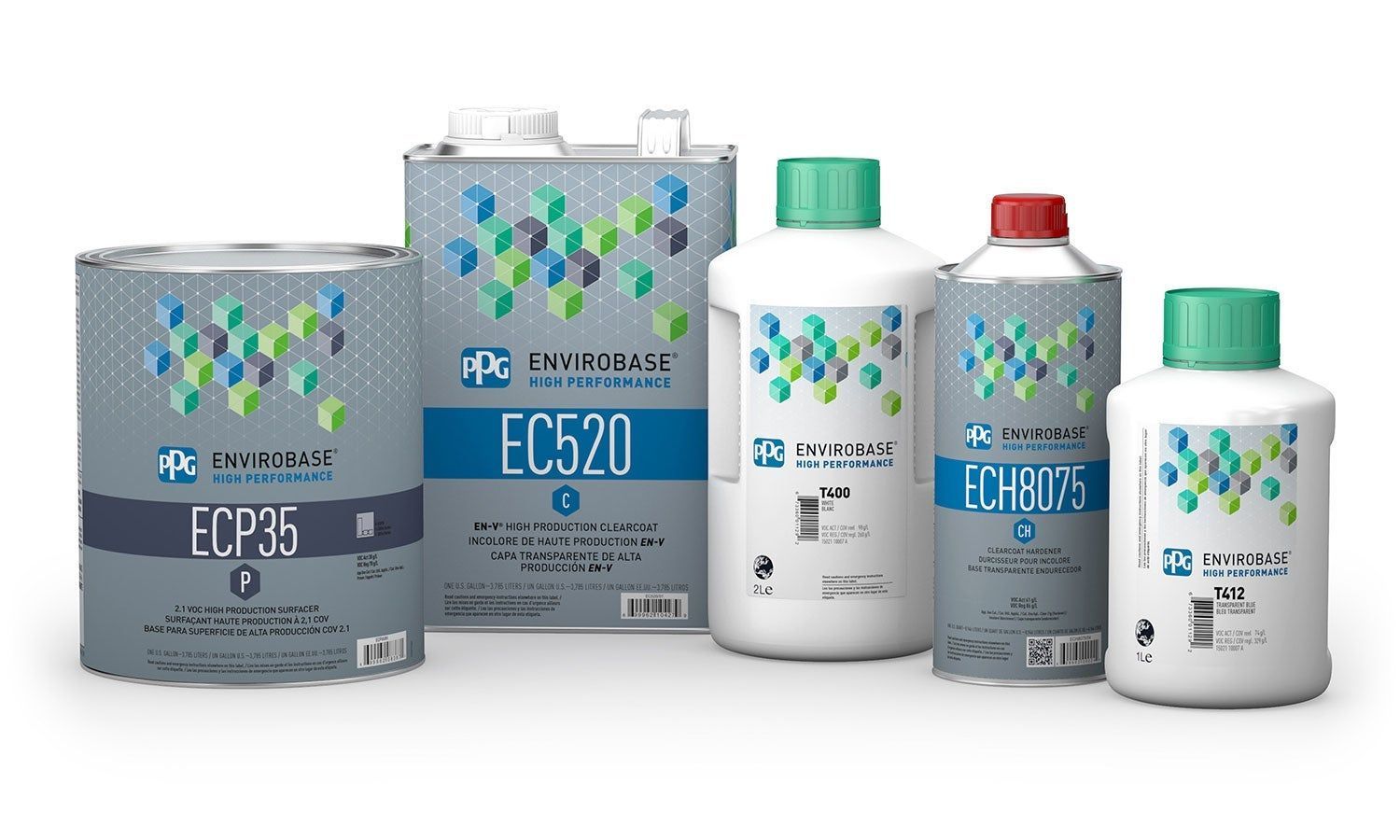 A group of bottles of paint are lined up on a white surface.