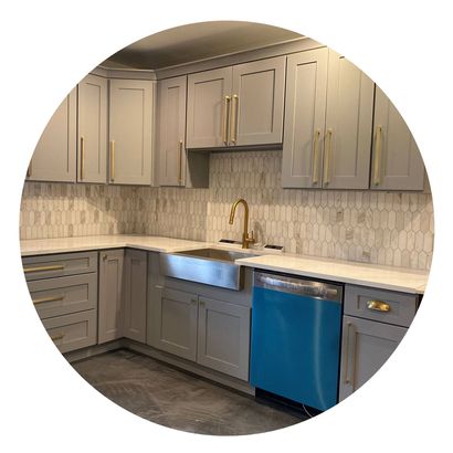 A kitchen with gray cabinets and a blue dishwasher.