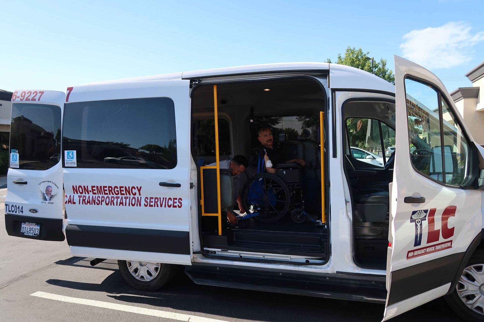 A man in a wheelchair is sitting in the back of a van