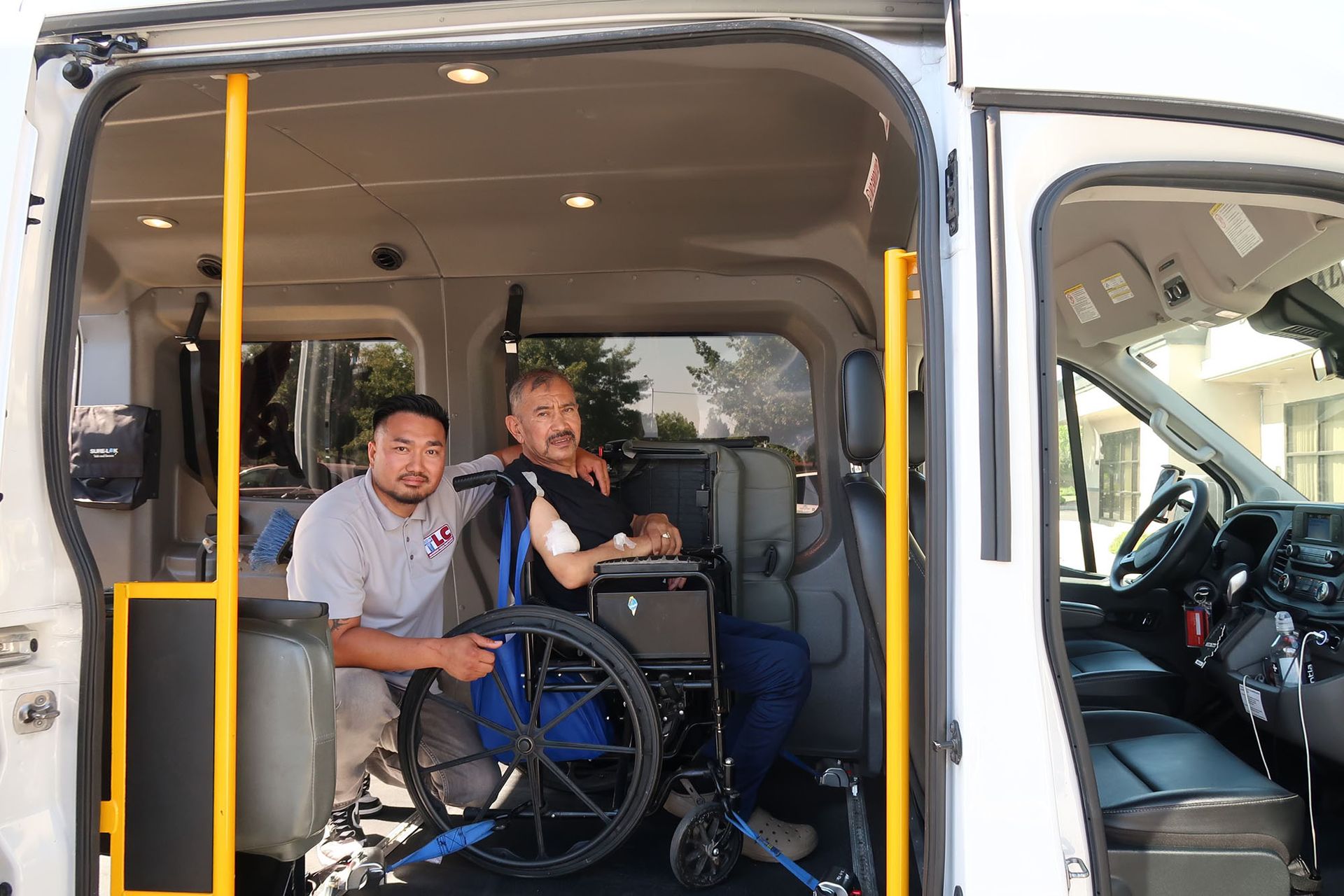 A man in a wheelchair is sitting in the back of a van