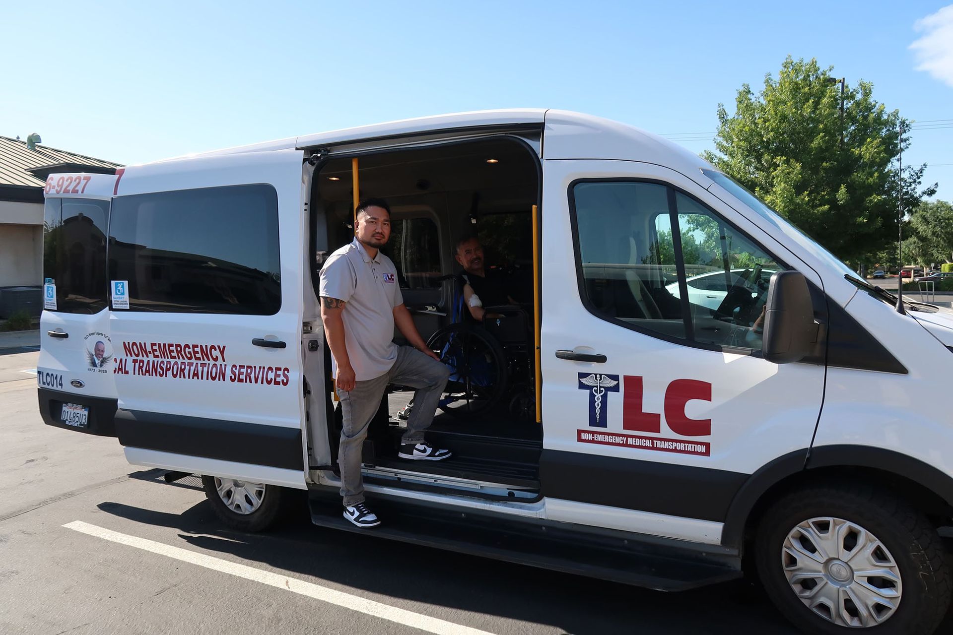 A man is getting out of a white van with the door open