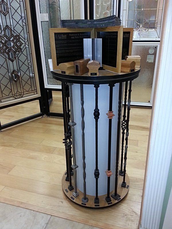 Display stand with iron baluster samples. Brown, black, and silver tones.