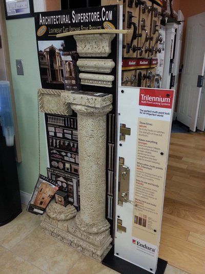 Display showcasing architectural elements and hardware samples; interior store setting.
