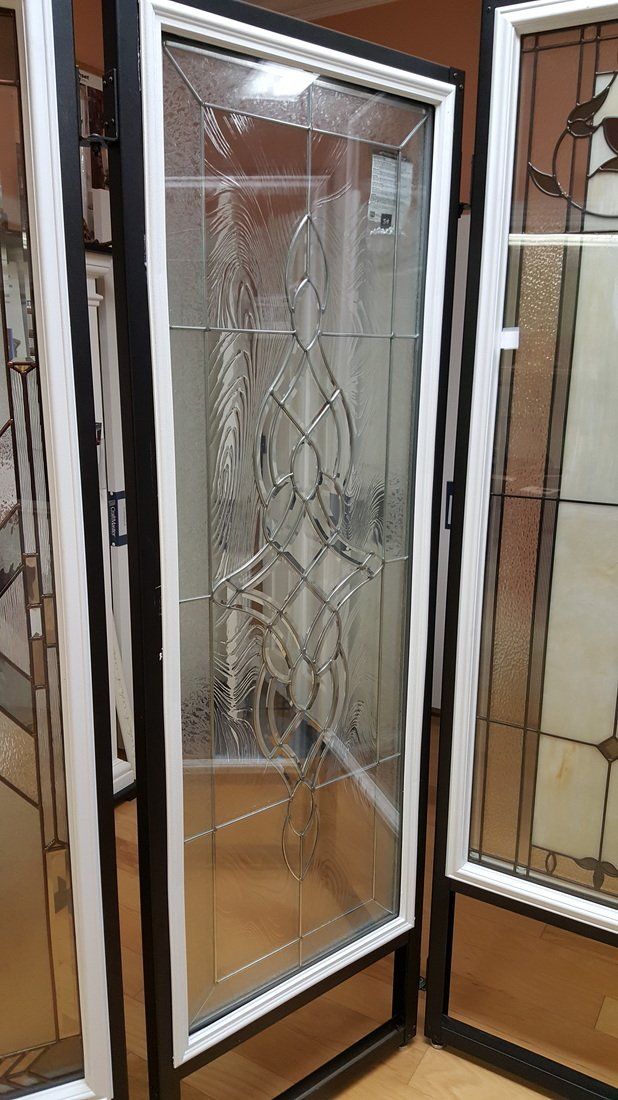 Black and white screen door with decorative glass panel.