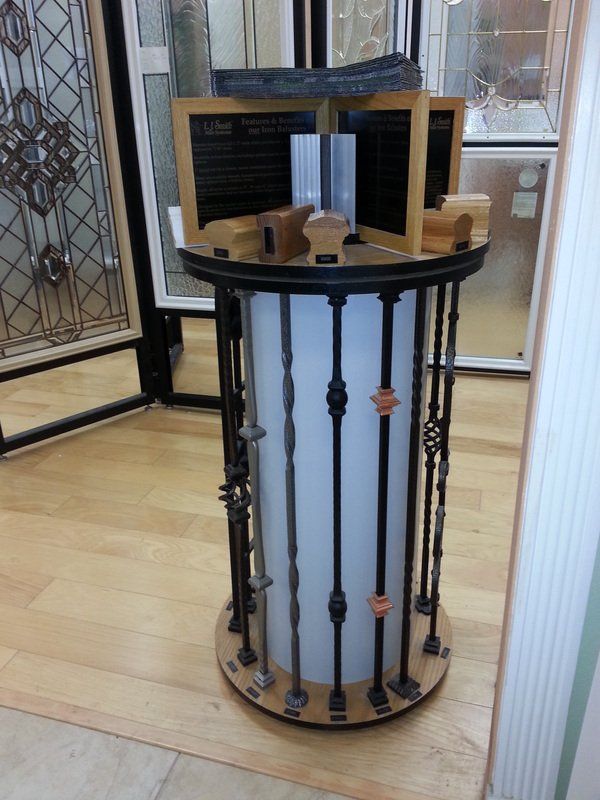 Display stand showcasing various black and silver iron baluster designs.