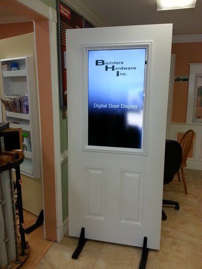 White door with digital display showing logo for 