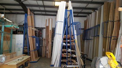 A warehouse with racks holding various wooden trim and molding.