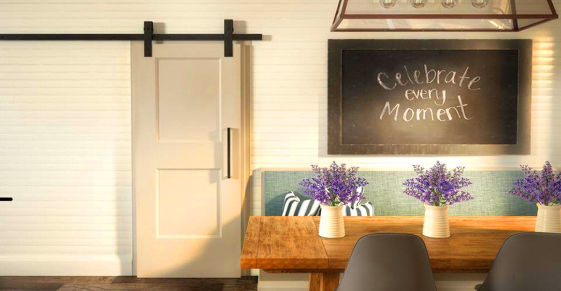 Barn door beside a table with vases of lavender and a chalkboard that reads