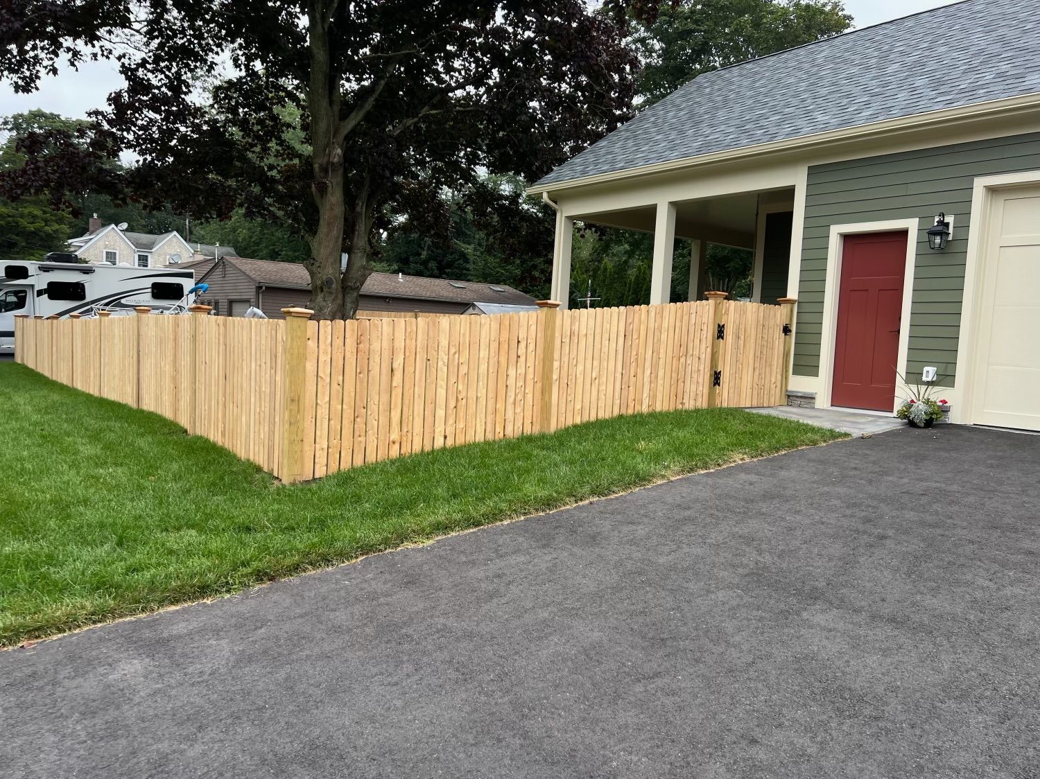 A house with a wooden fence in front of it