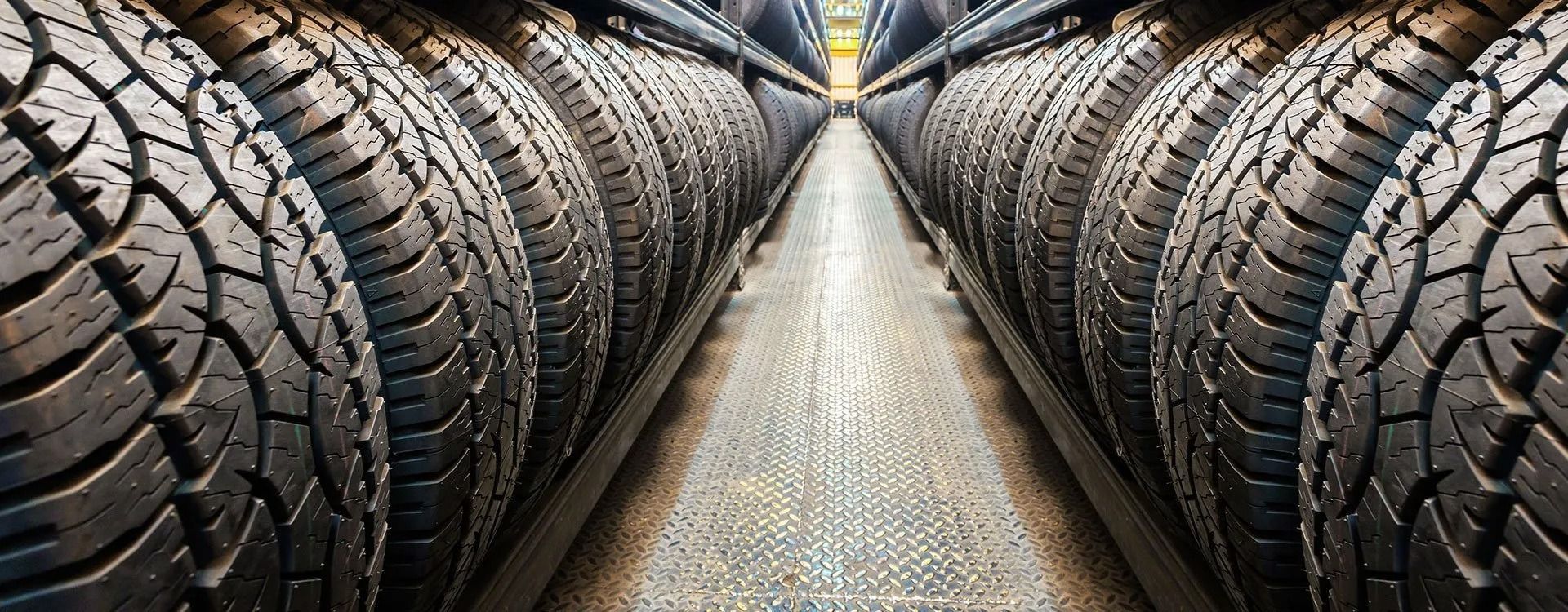 A warehouse filled with lots of tires stacked on top of each other.