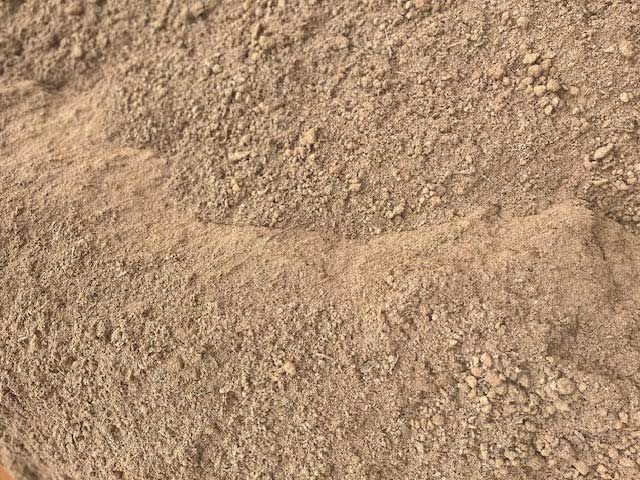 Close-up view of light brown, grainy powder.