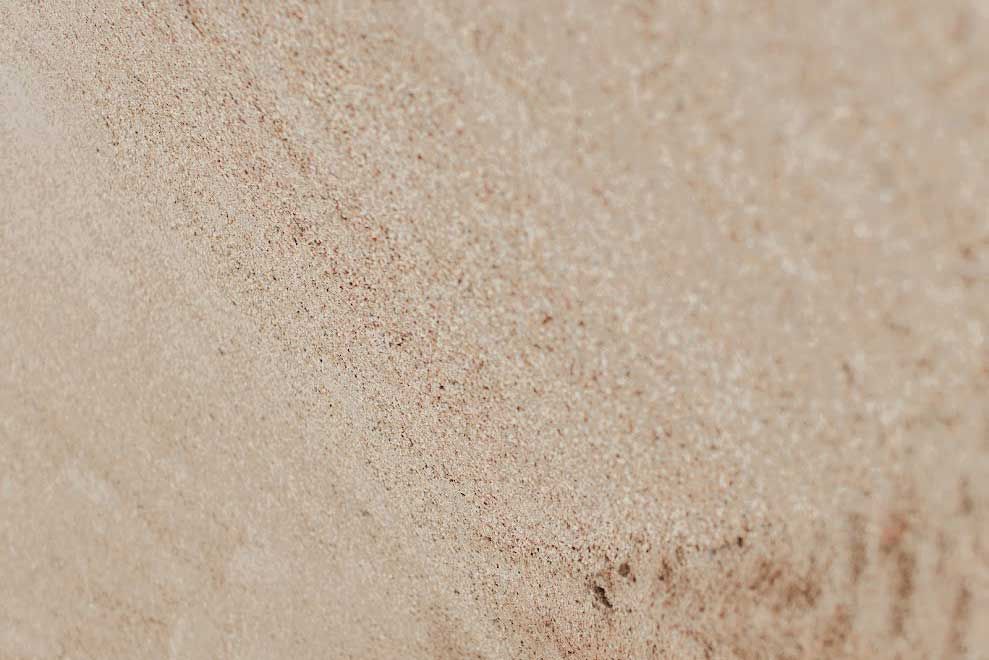 Close-up view of beige, textured surface.