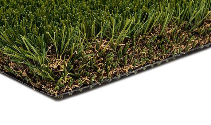 Close-up of artificial turf showing green grass blades and brown thatch on a black backing.