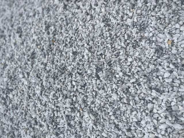 Close-up of small, light gray gravel stones covering a surface.