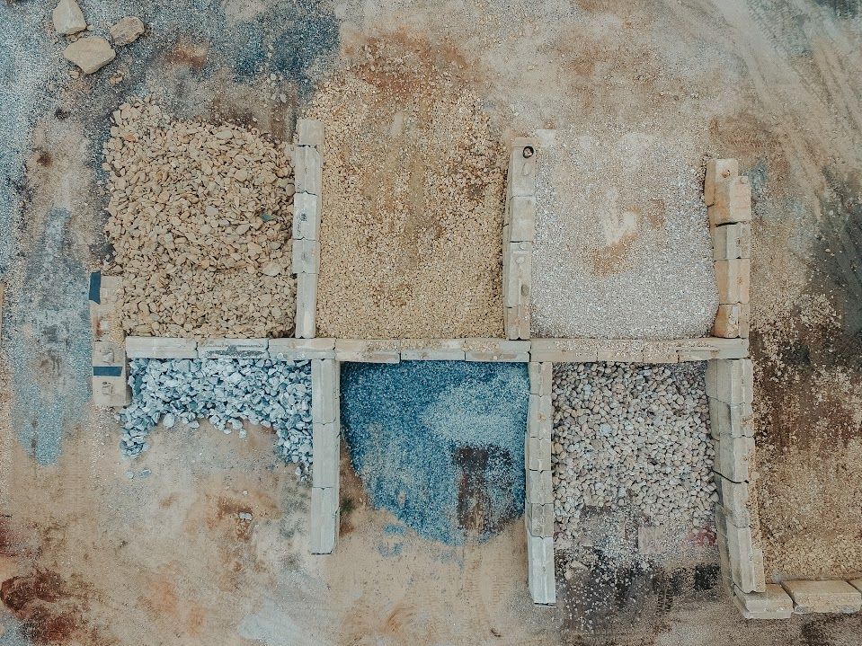 Overhead view of six square sections, each filled with different colored gravel.