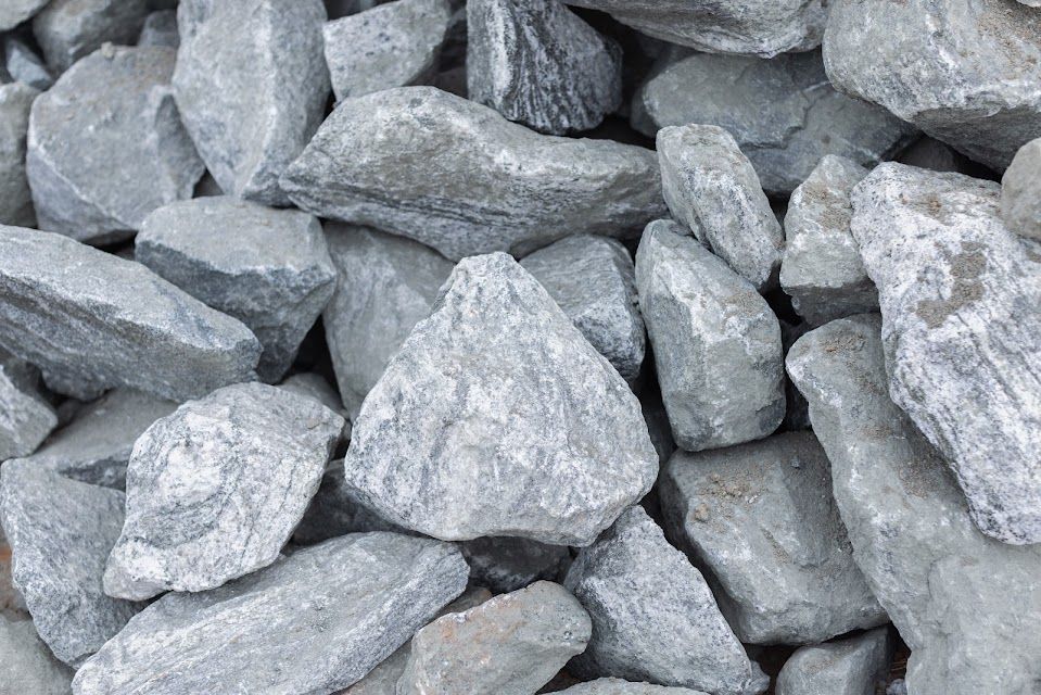 Pile of gray, irregularly shaped landscaping rocks.