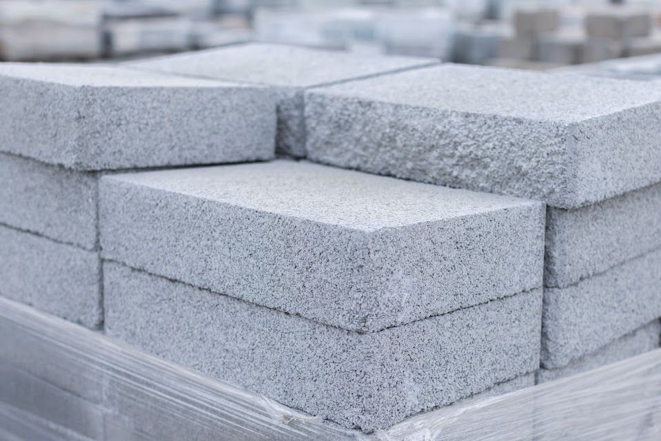 Gray rectangular concrete blocks stacked on top of each other.