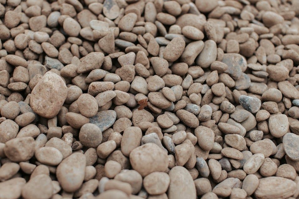 Tan and gray smooth river rocks.