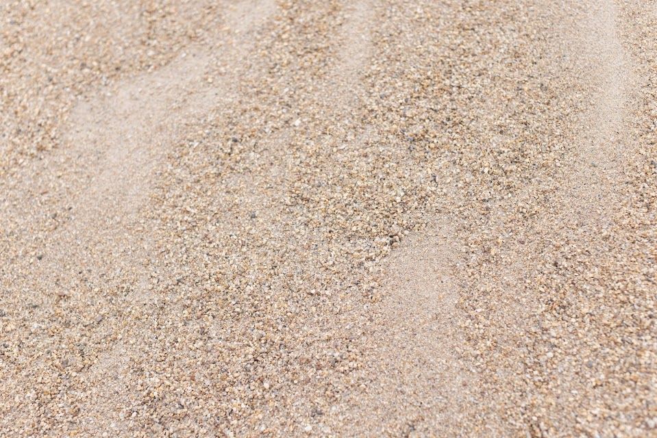 Close-up of beige-colored sand, showing small grains.